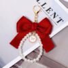 Çelës elegant me fjongo të kuqe & perla klasike